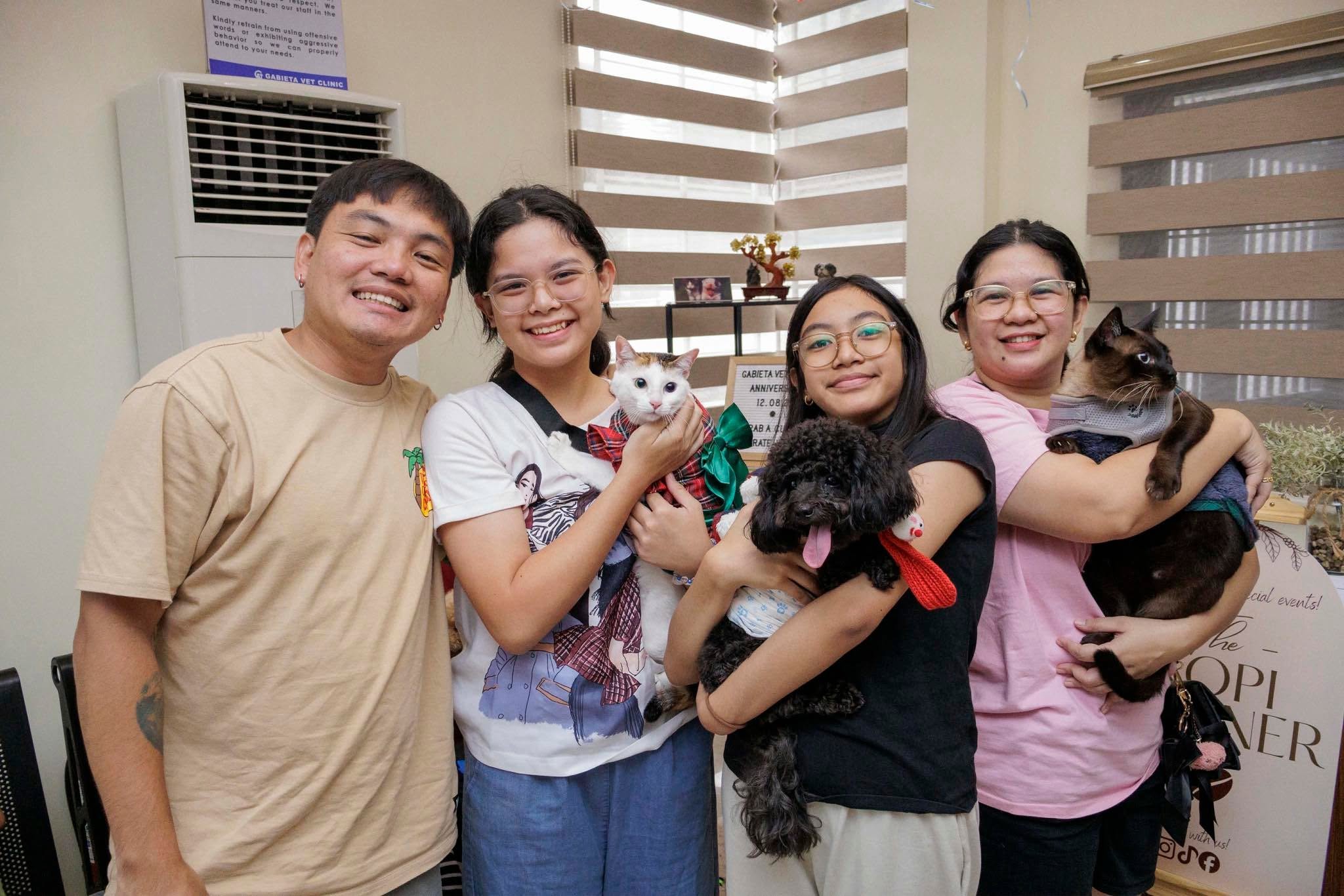 Groomed happy dog with owners at Gabieta